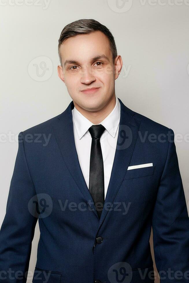 Portrait of handsome man in black blue suit photo