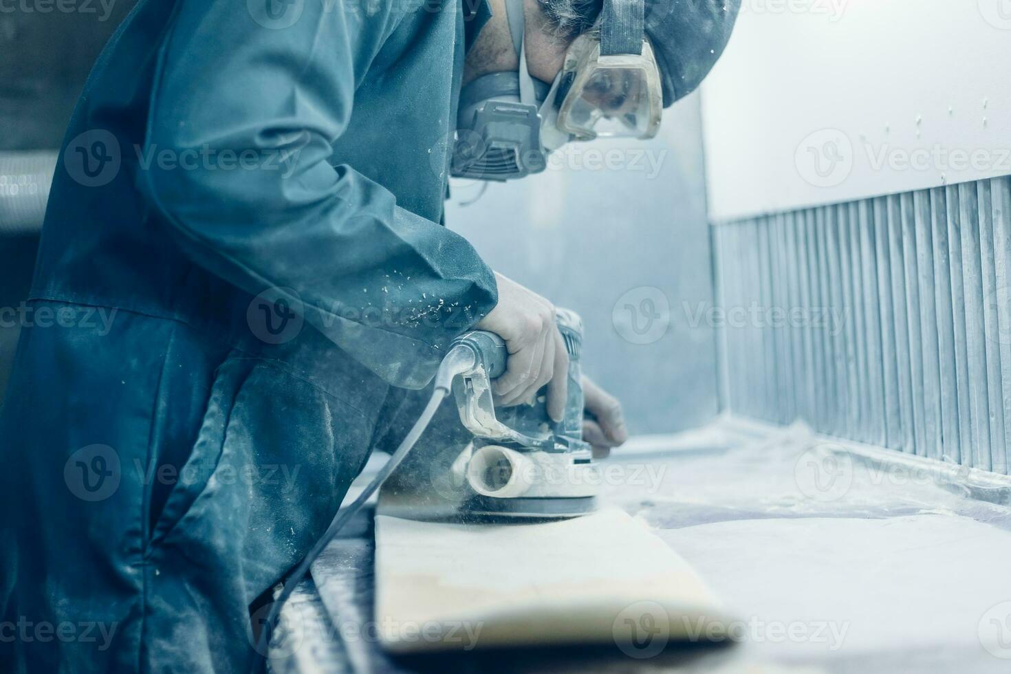 A carpenter cuts a board with an electric jigsaw. photo