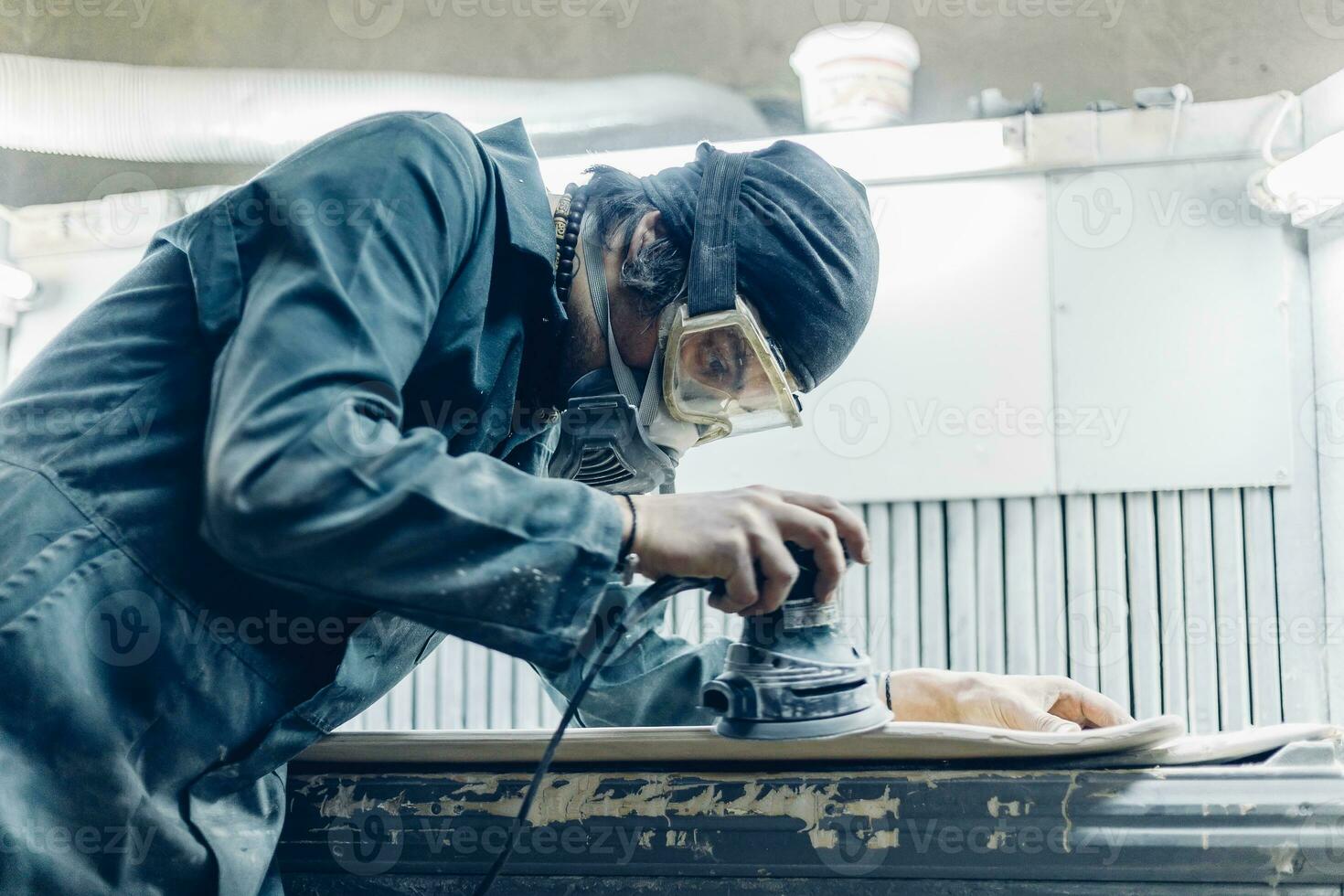 A carpenter cuts a board with an electric jigsaw. photo