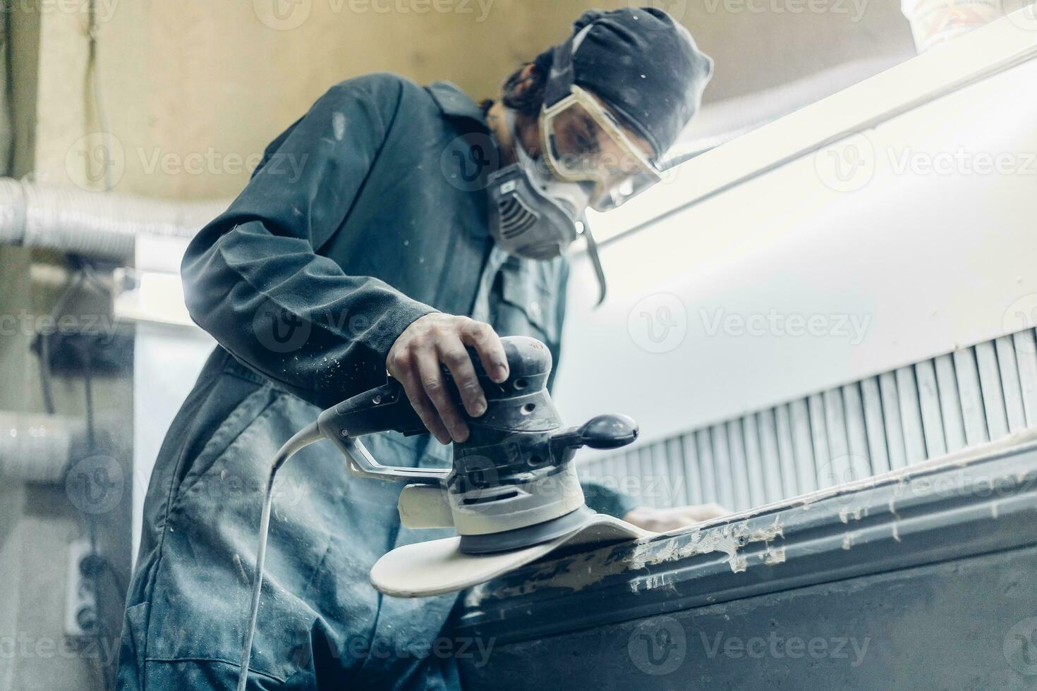 A carpenter cuts a board with an electric jigsaw. photo