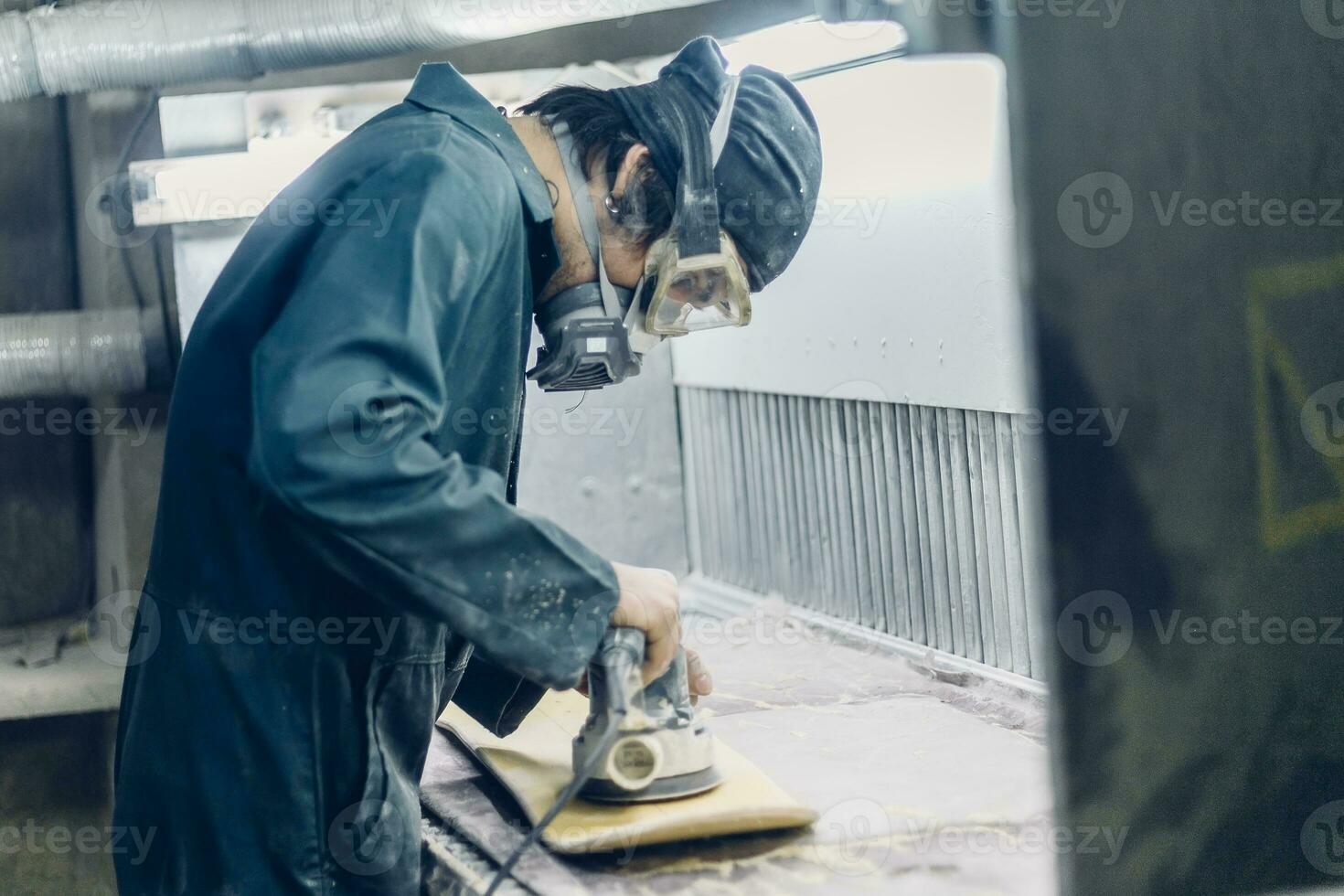 A carpenter cuts a board with an electric jigsaw. photo