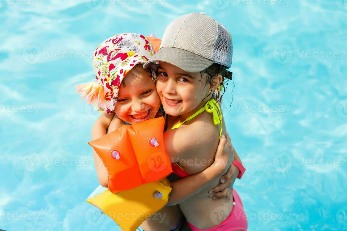 two little girls playing in the pool photo