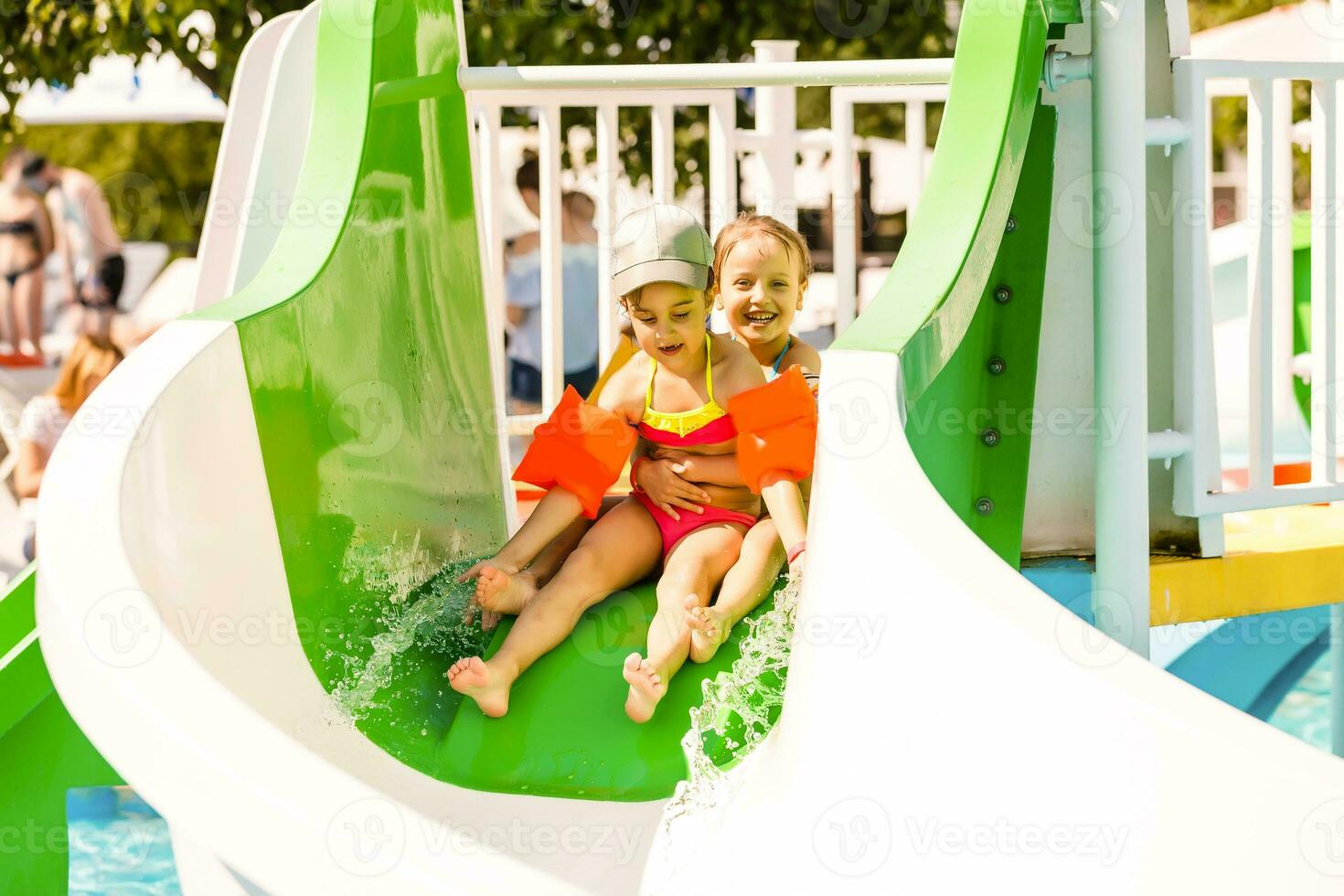 two little girls playing in the pool photo