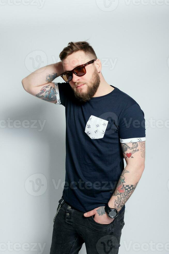 Brutal bearded boy with tattoo photo