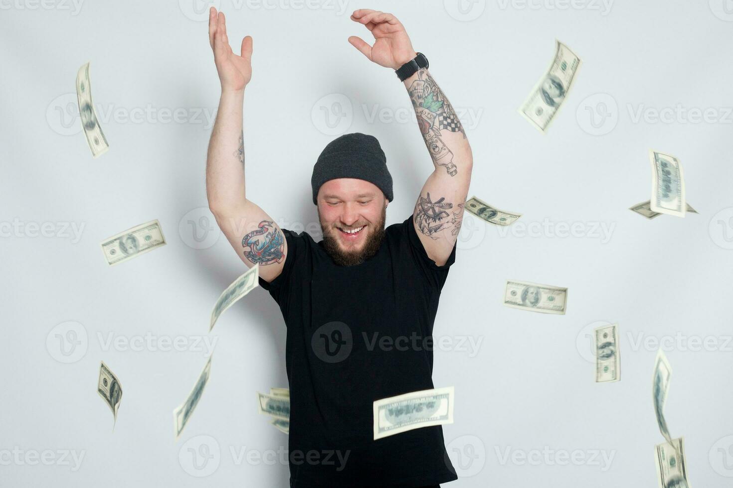 Young man throws money to camera. photo