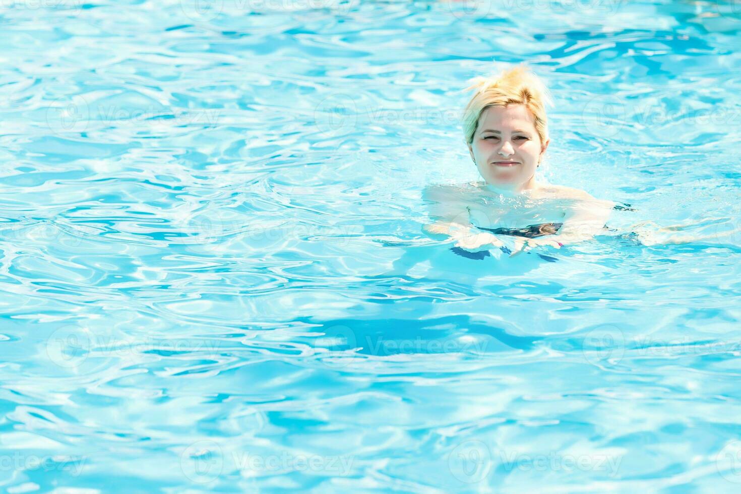 Young woman in the swimming pool photo