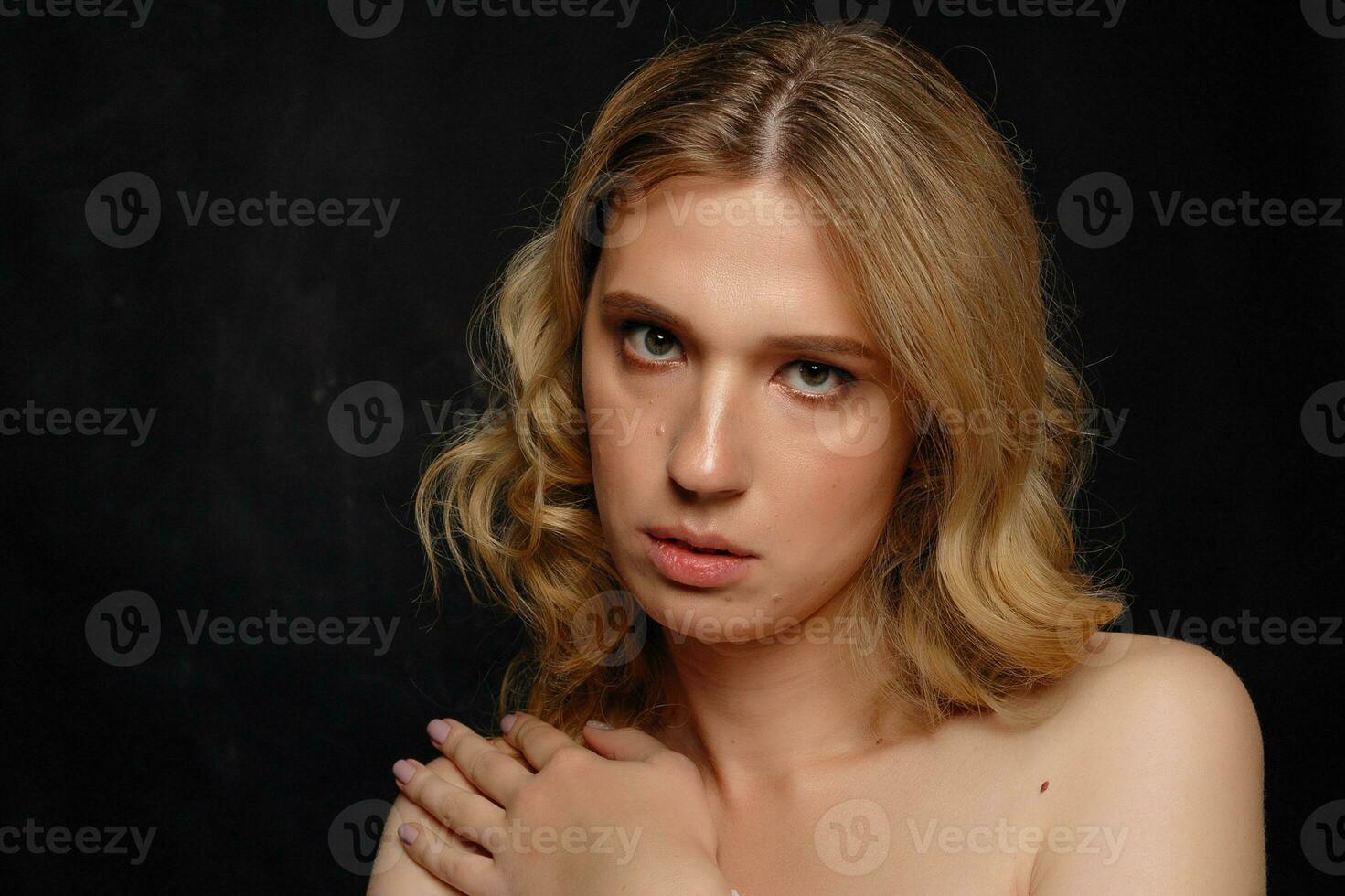 beautiful young transgender with blond hair, dark blue background photo