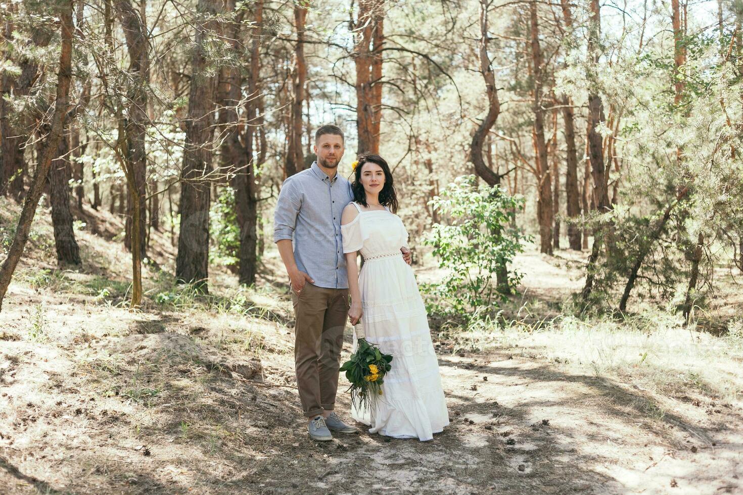 Wedding walk in the pine forest. Sunny day. photo