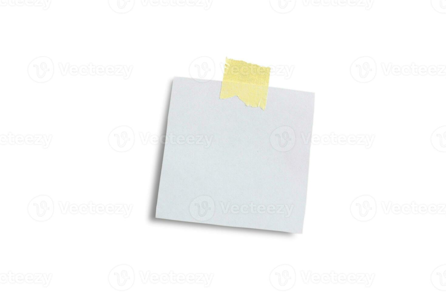 Paper sheet with yellow stationery tape isolated on white paper. photo