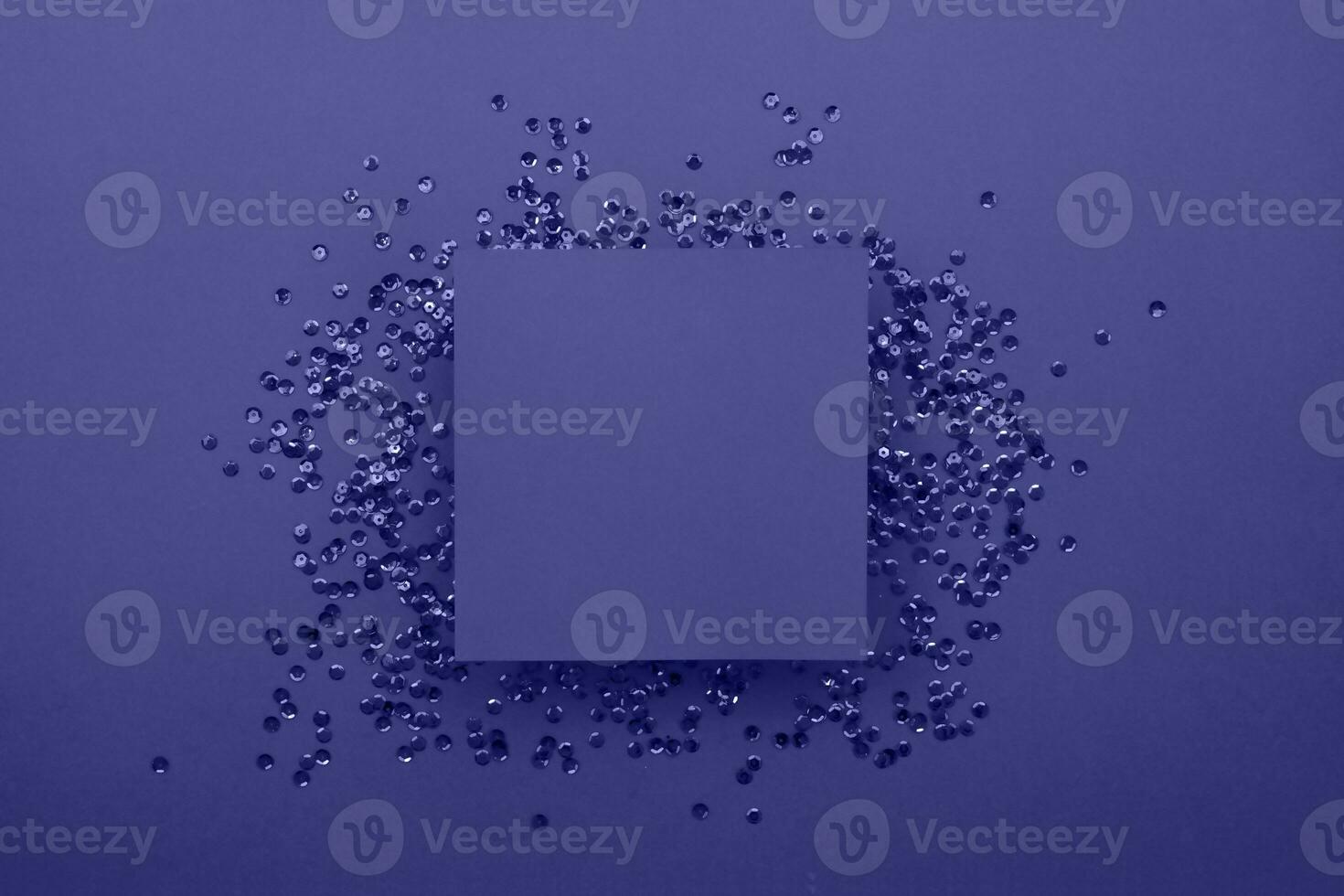 Purple card on a purple background with purple sequins. Preparation for various celebrations. Festive background photo