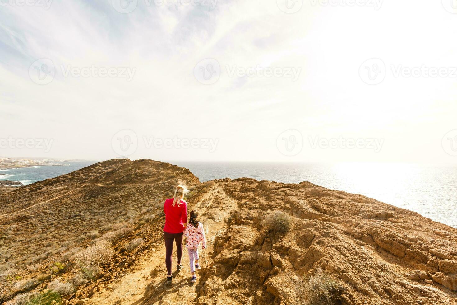 Family holiday on Tenerife, Spain. Mother with children outdoors on ocean. Portrait travel tourists - mom with kids. Positive human emotions, active lifestyles. Happy young family on sea beach photo