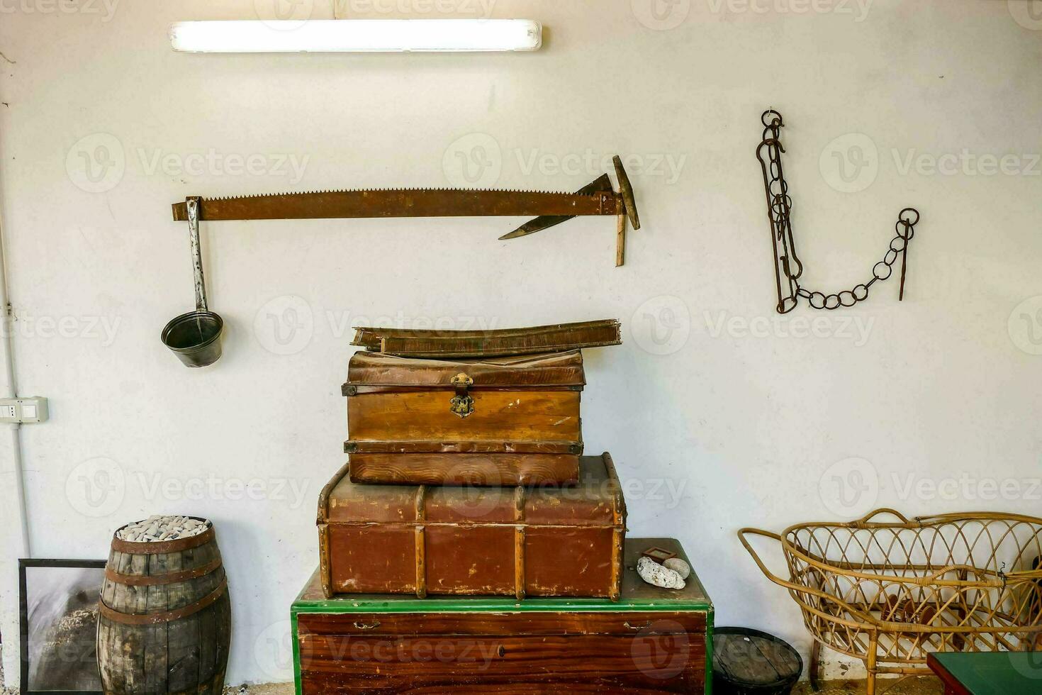 a room with a chest of drawers, a trunk and a rope photo