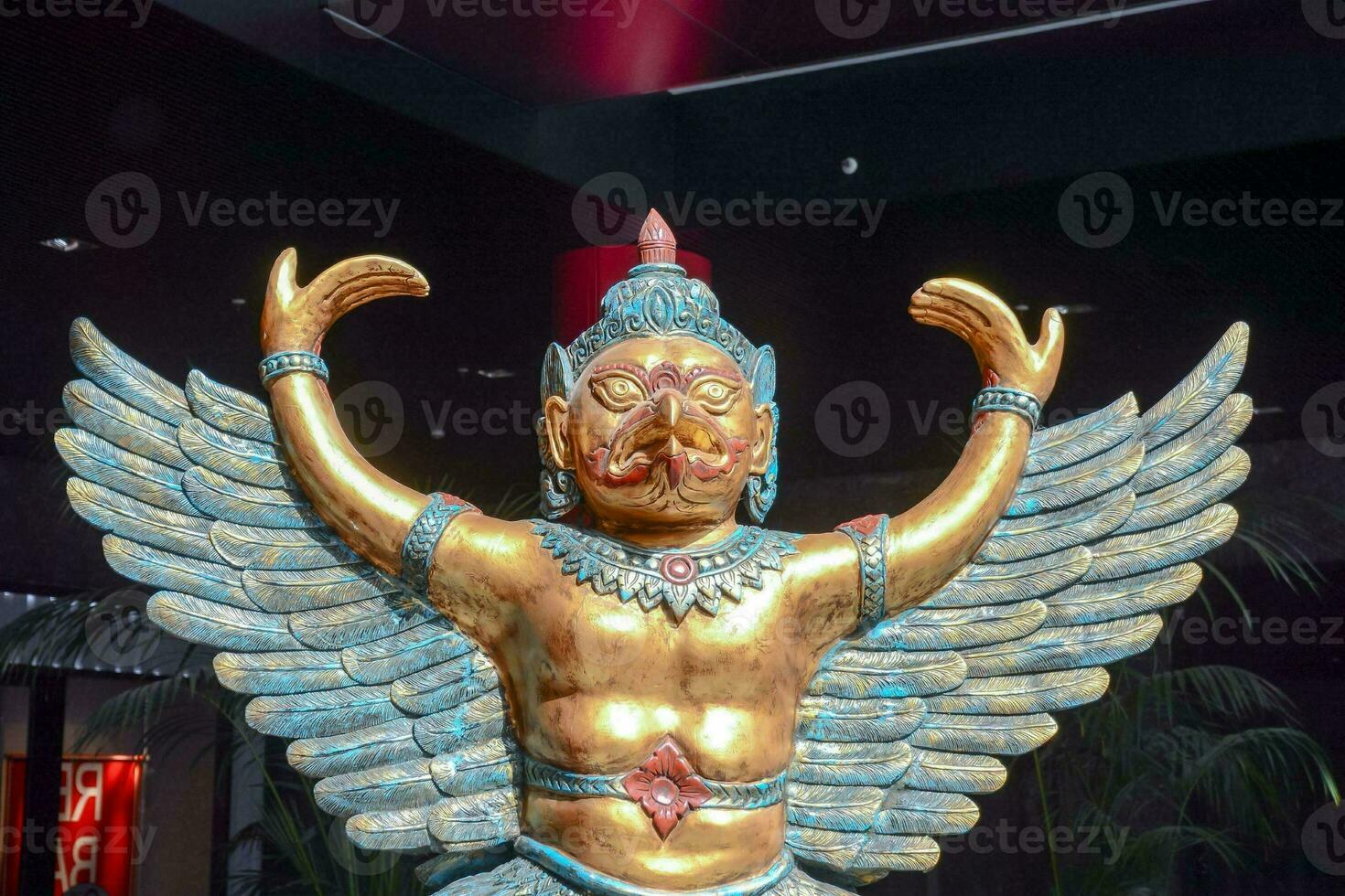 a statue of a man with wings on display photo