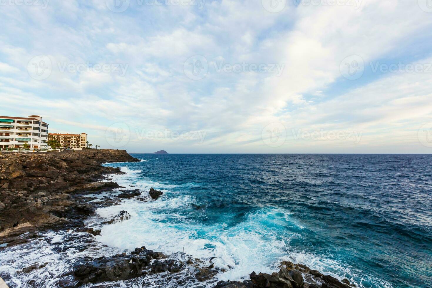 ocean waves hit and crash against stones photo