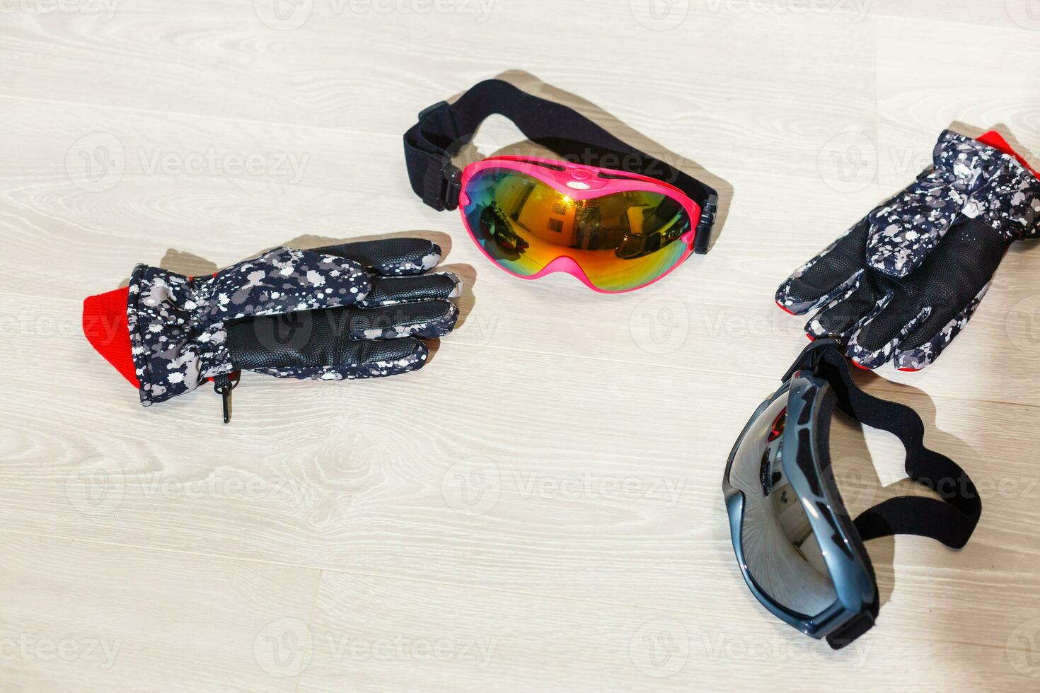 Ski goggles and winter gloves on white background photo