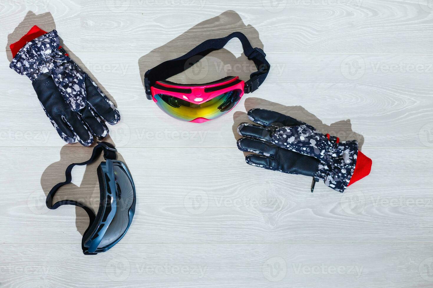 Ski goggles and winter gloves on white background photo