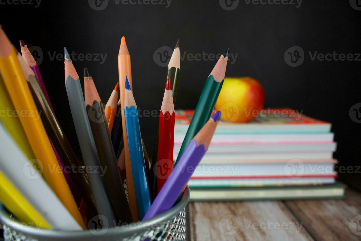 Pencils on a background of books and apples. Back to school concept. Background for design photo
