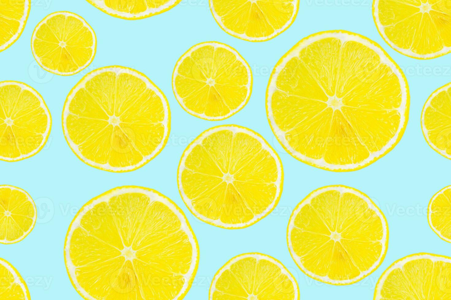 Summer seamless pattern. Lemon slices on a light blue background. photo