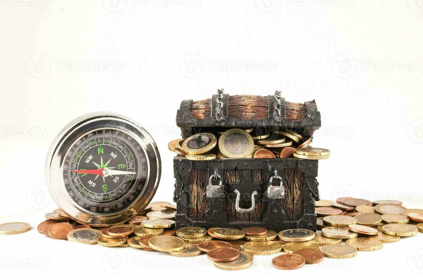a wooden chest with coins and a compass photo