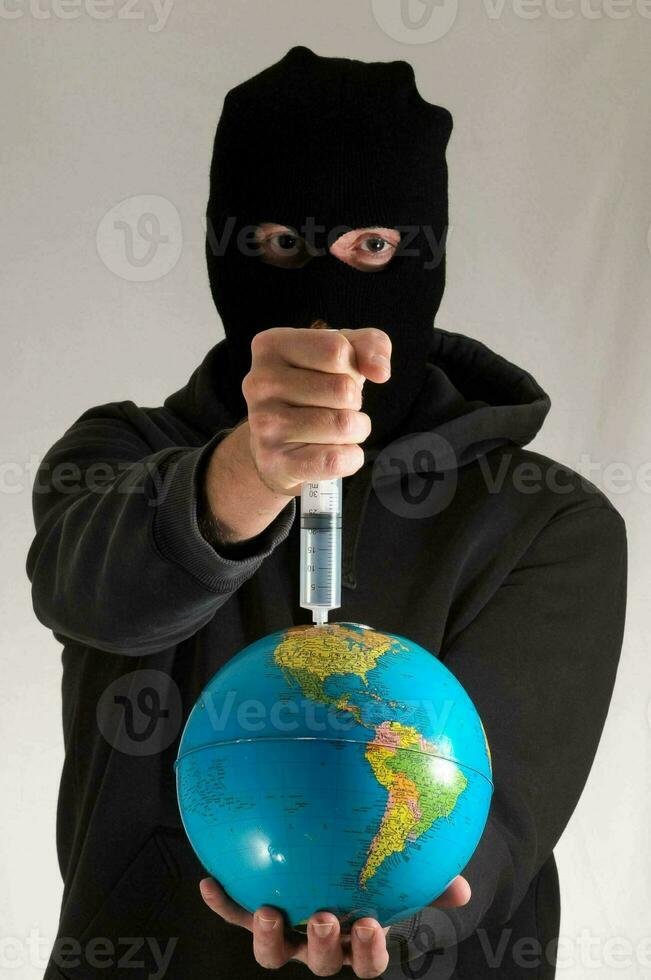 a man in a black mask holding a globe photo