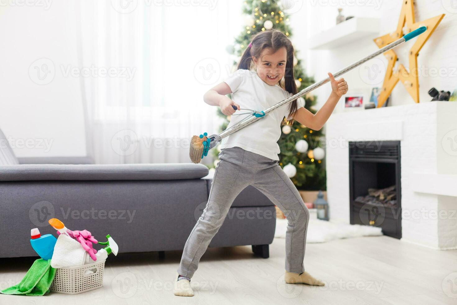 little girl cleaning the apartment before christmas photo