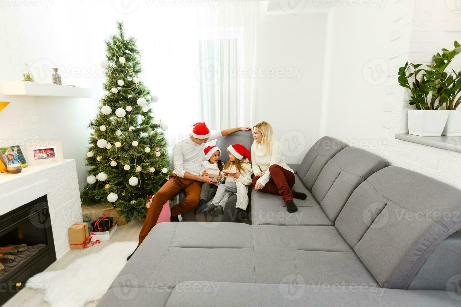 Happy family playing with Christmas gifts at home photo