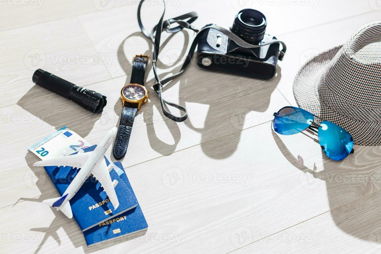 Travel and vacation concept. Trip accessories and items. Airplane toy over passport with airplane tickets. Top view flat lay with copy space photo