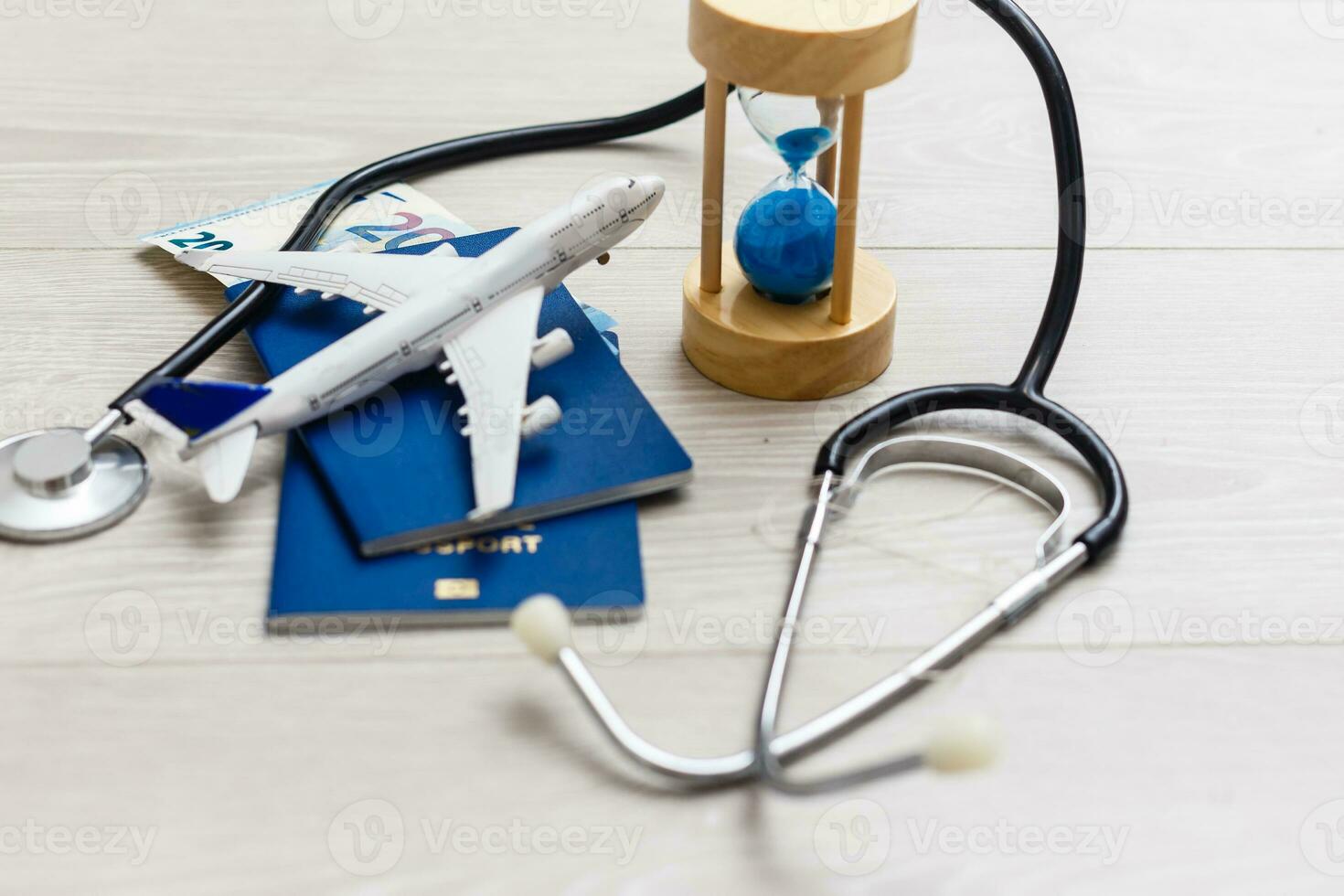 passport,stethoscope, airplane toy. Travel Insurance. photo