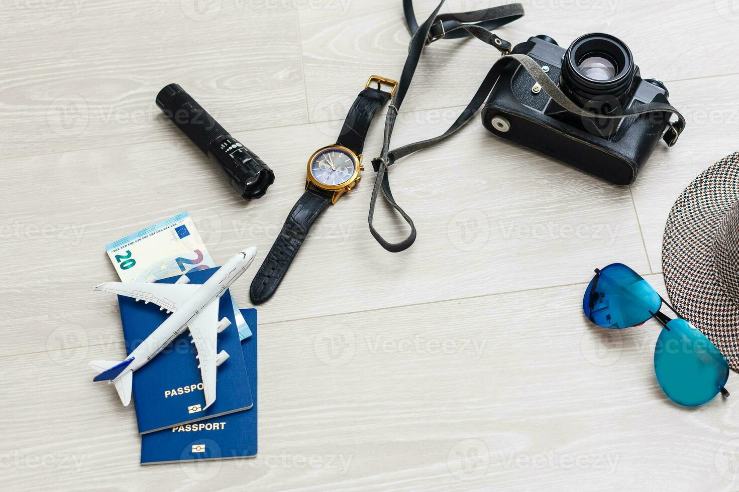 Travel preparation. A lot of objects are scattered on gray background - a camera, tickets, documents, a toy plane. Family holidays, holidays near the sea, holidays. photo