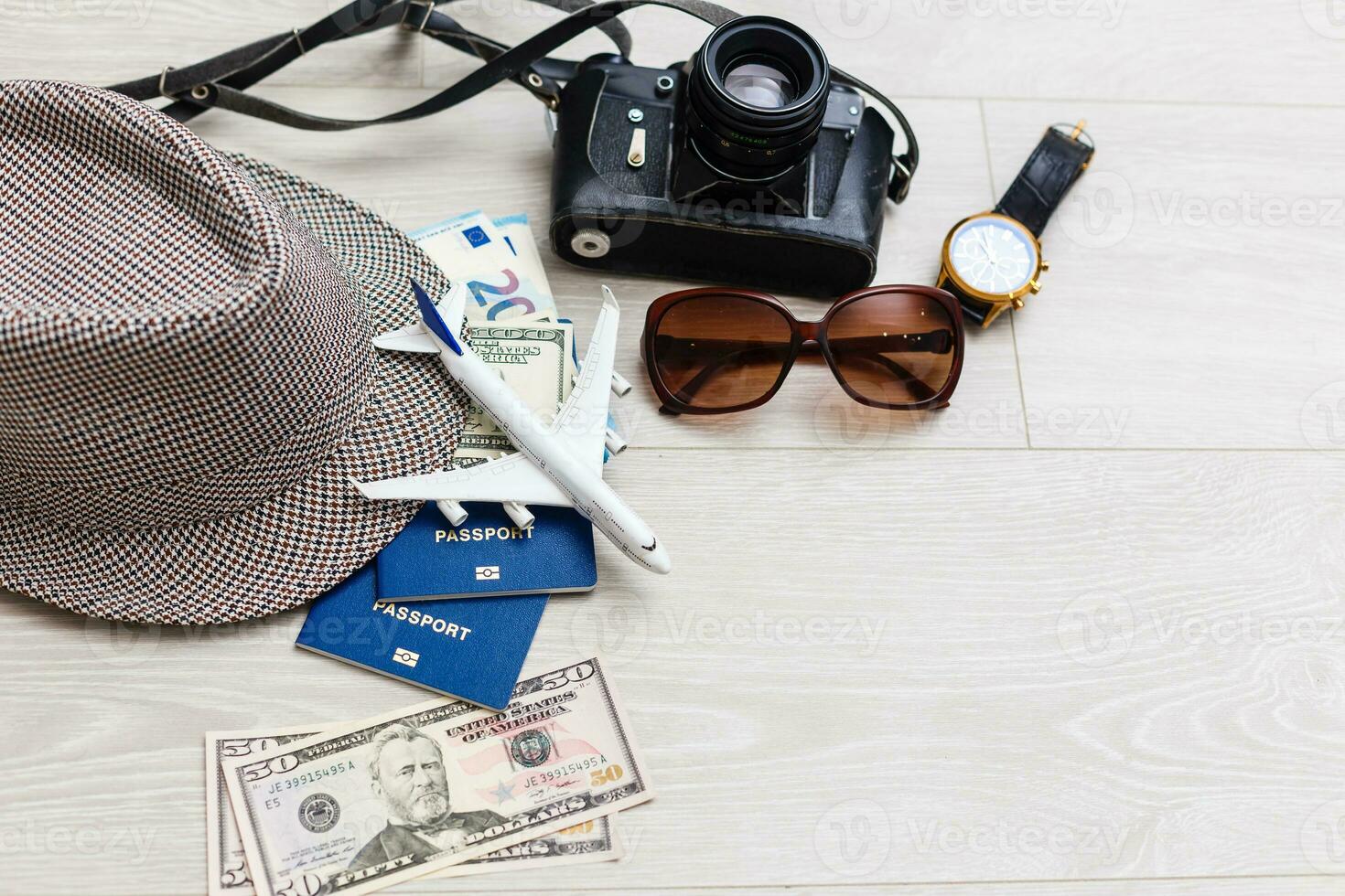 Travel and vacation concept. Trip accessories and items. Airplane toy over passport with airplane tickets. Top view flat lay with copy space photo