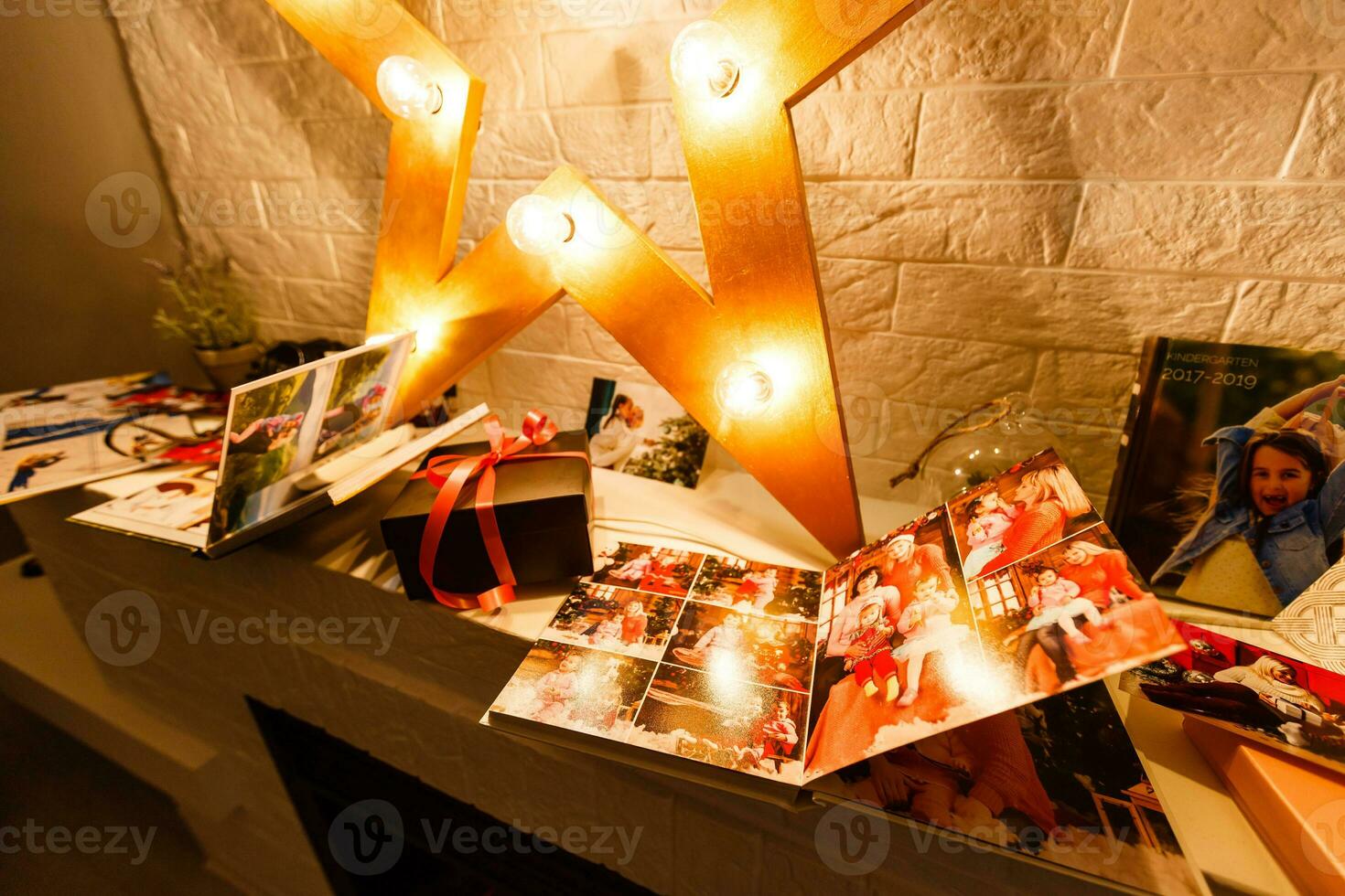 book together near Christmas tree in front of fireplace photo