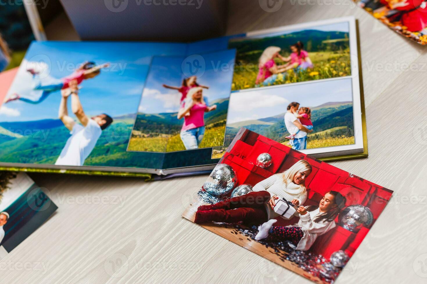 New Year celebrating. Photobook with photos of summer travel under the Christmas tree