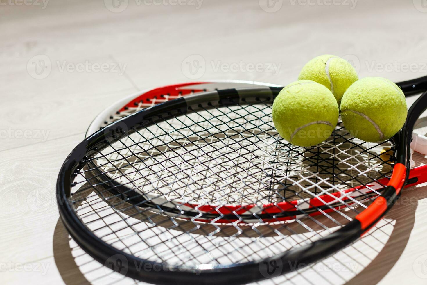 sport, fitness, healthy lifestyle and objects concept - close up of tennis racket with balls photo