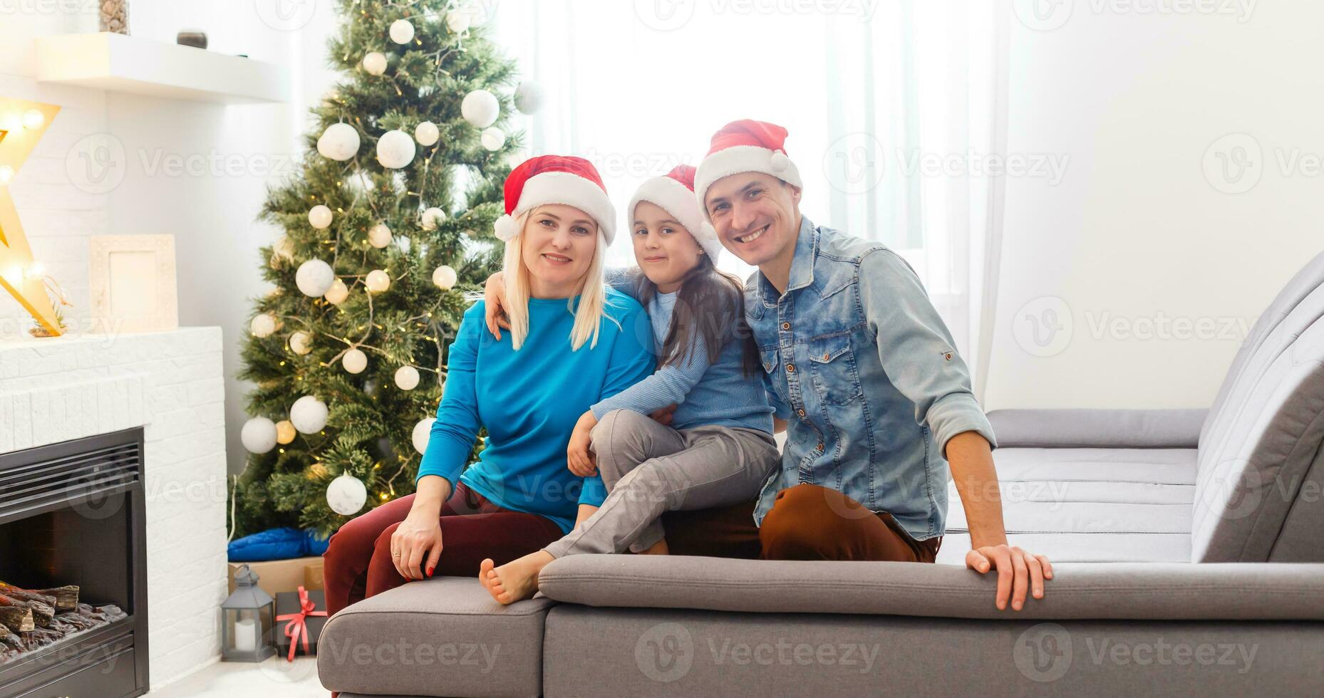 Young family on Christmas morning exchanging presents and enjoying their time together. photo