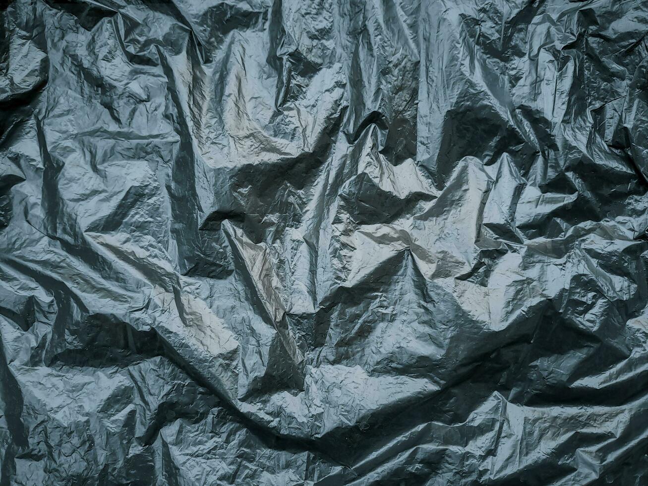 Black and white texture of wrinkled plastic or crumpled plastic of reflecting. Grungy copy space photo