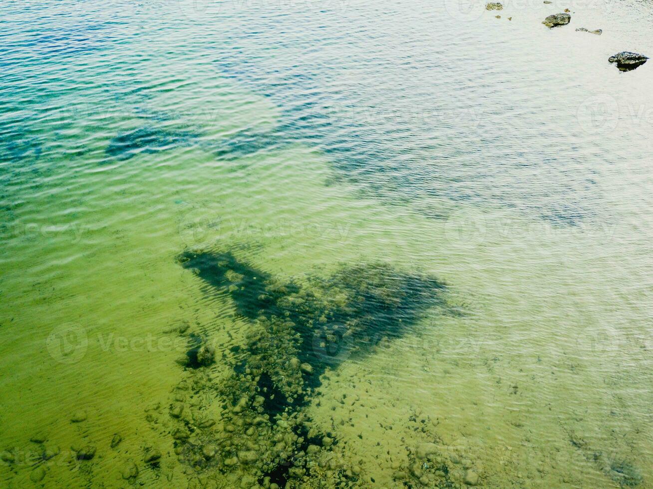 Aerial shot of the sea surface with crystal clear water photo