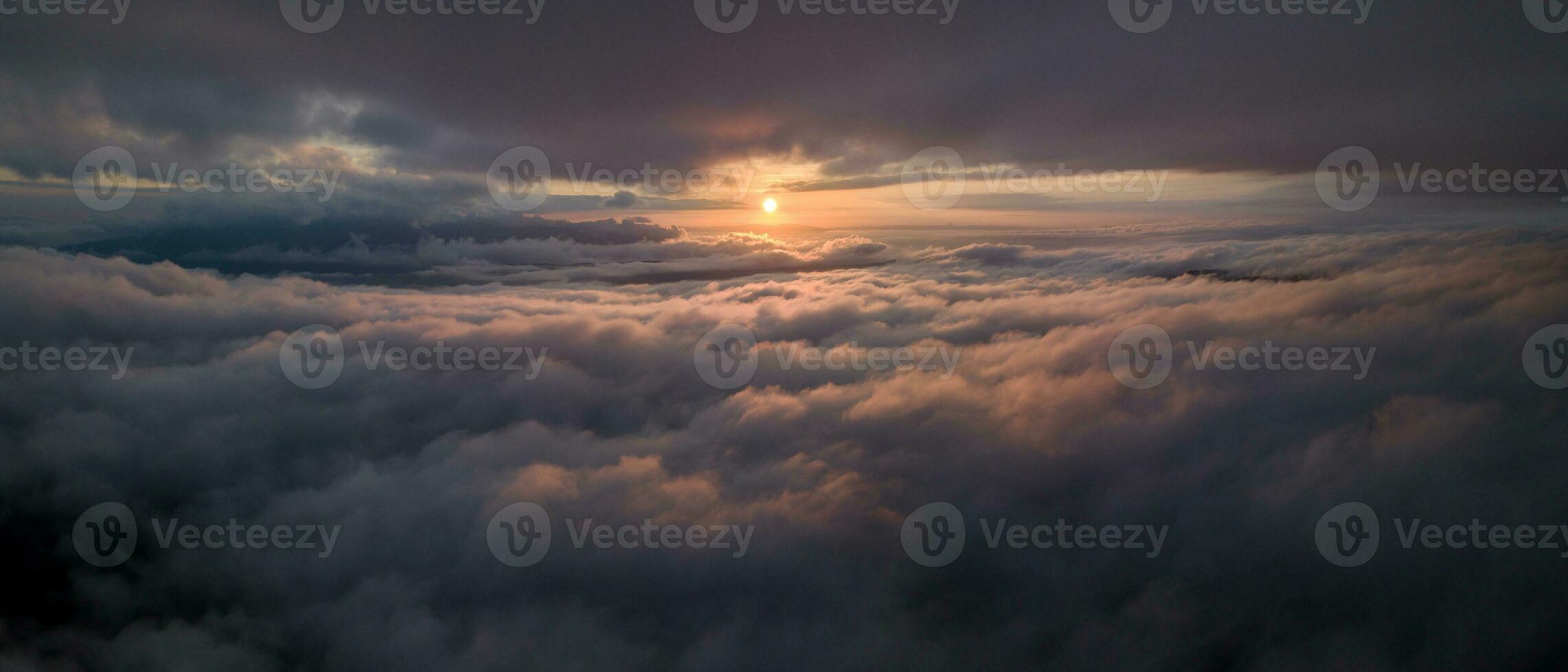 Panorama shot of colorful light of sunrise over rainforest mountains with fog and cloud inversion for natural cinematic of national park and wildlife reserve area photo