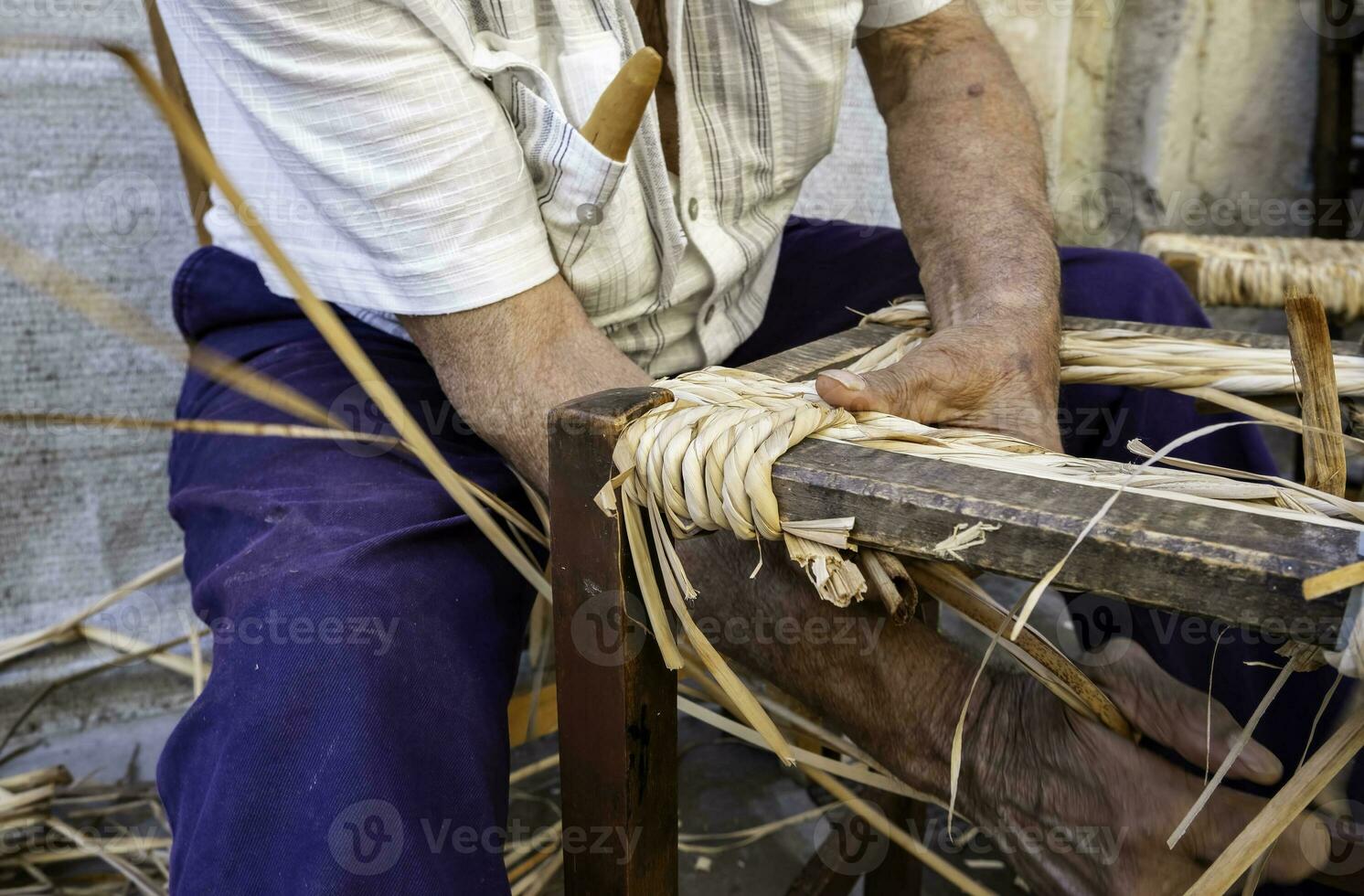 Man working with wicker photo