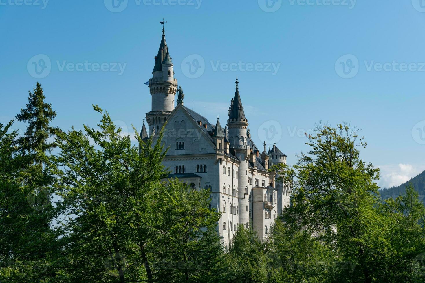 Majestic royal castle of Neuschwanstein with a pure blue sky on the background photo