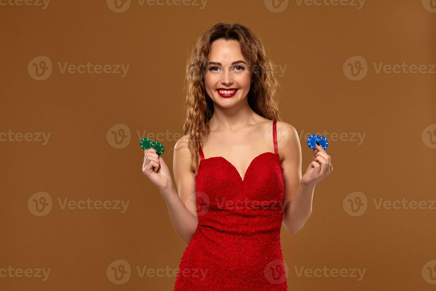 Casino concept. Portrait of young brown-haired caucasian woman, playing in casino. Roulette, poker chips, cards, wheel, brown background photo