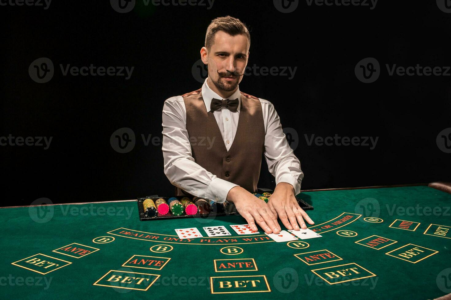 Croupier behind gambling table in a casino. photo