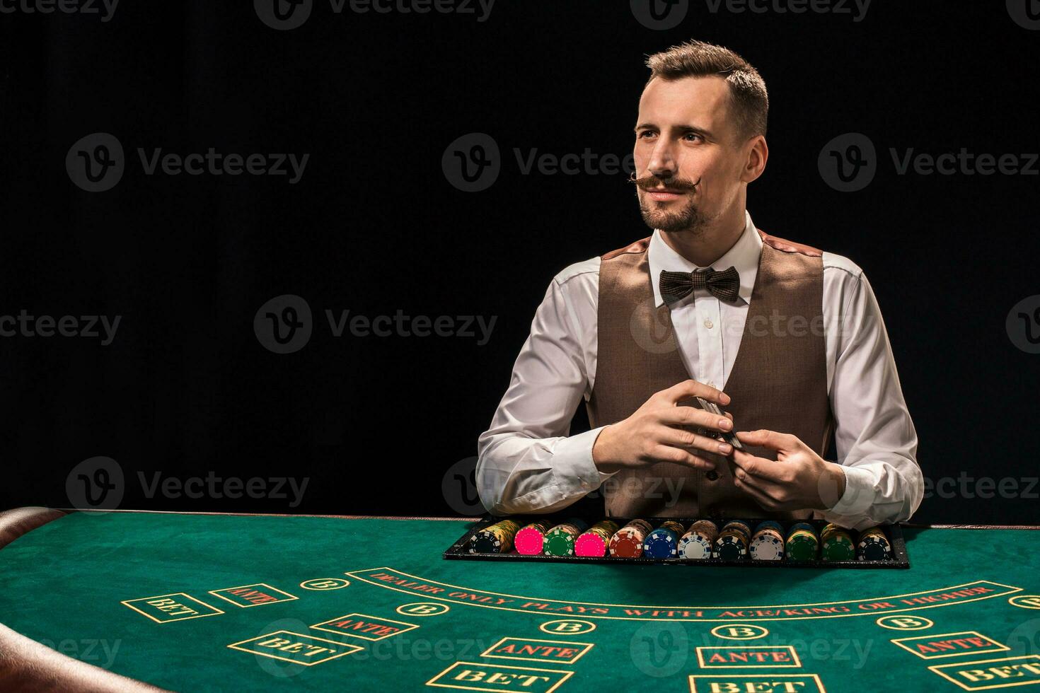 Croupier behind gambling table in a casino. photo