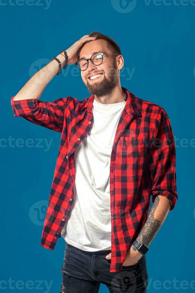 Emotional and people concept young bearded man in checkered shirt. Hipster style. photo
