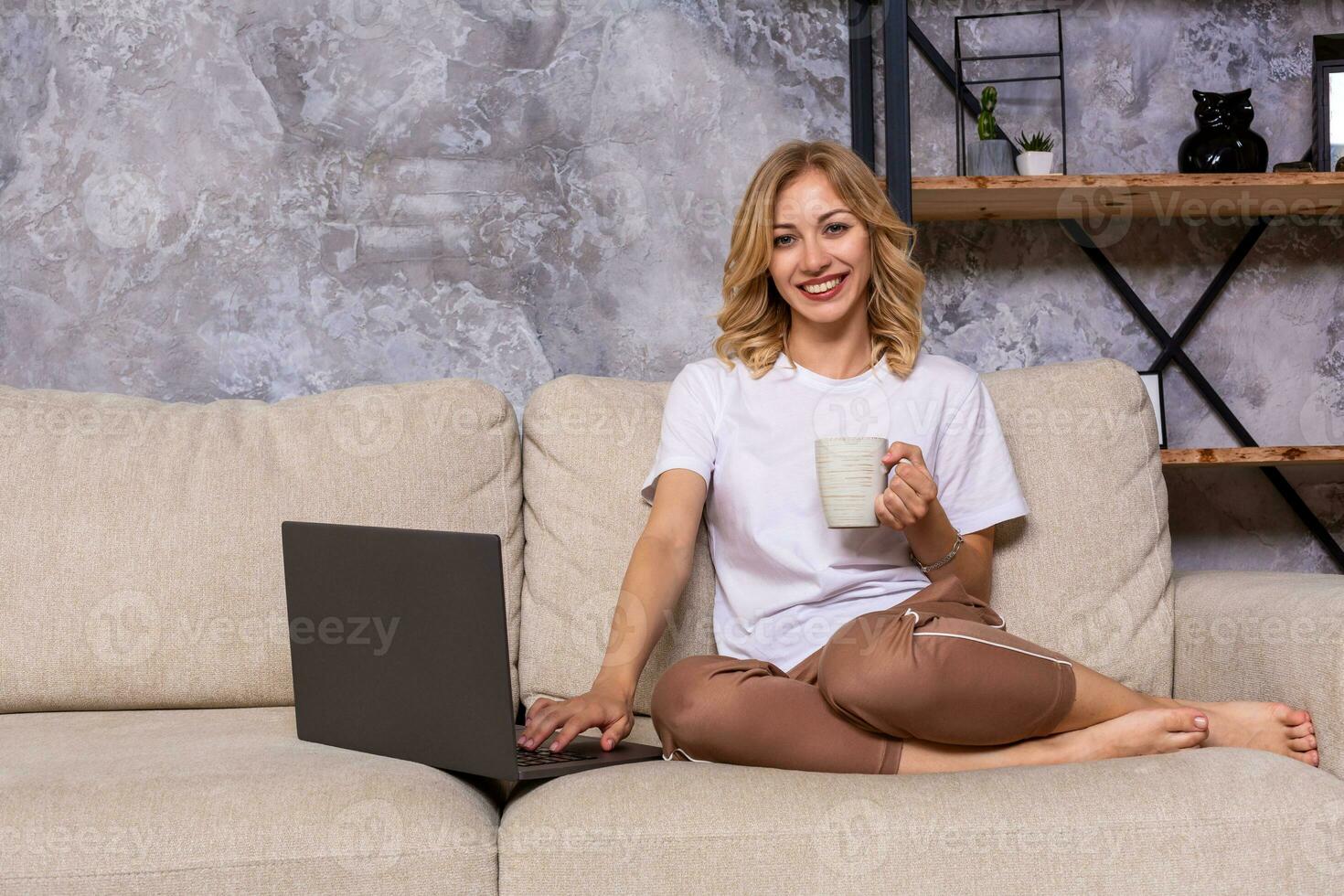 Young beautiful woman using laptop computer smiling happy watching and browsing or doing online internet shopping at home. photo