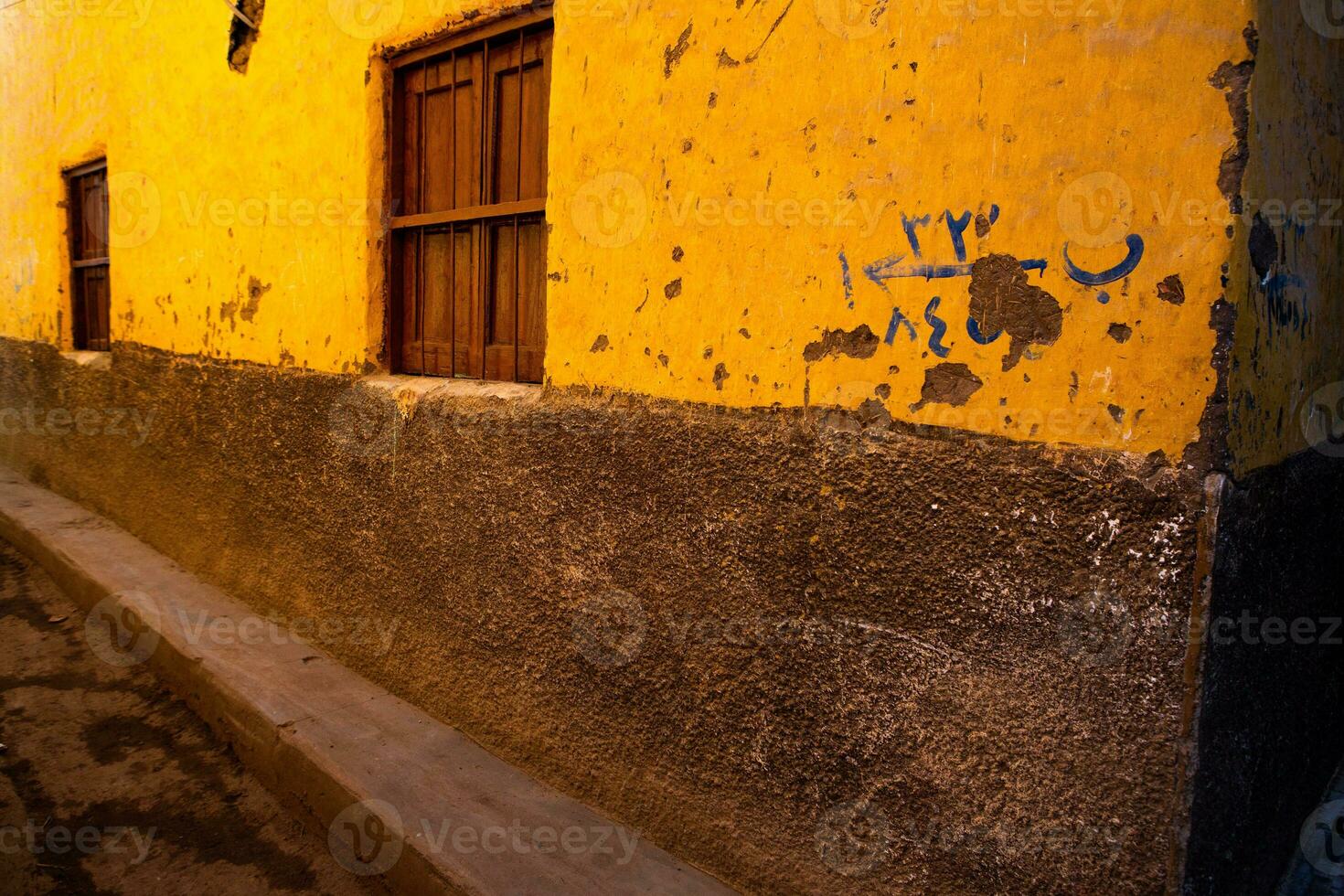 Colourful exterior wall of a Nubian house in Egypt. Typical African village houses facade. Medieval street. photo