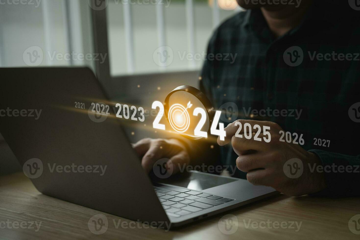 Trends 2024 year concept. Man using magnify glasses laptop and showing virtual sequence count down years 2024 wording for marketing monitor and business planning new year. Technology new year concept. photo