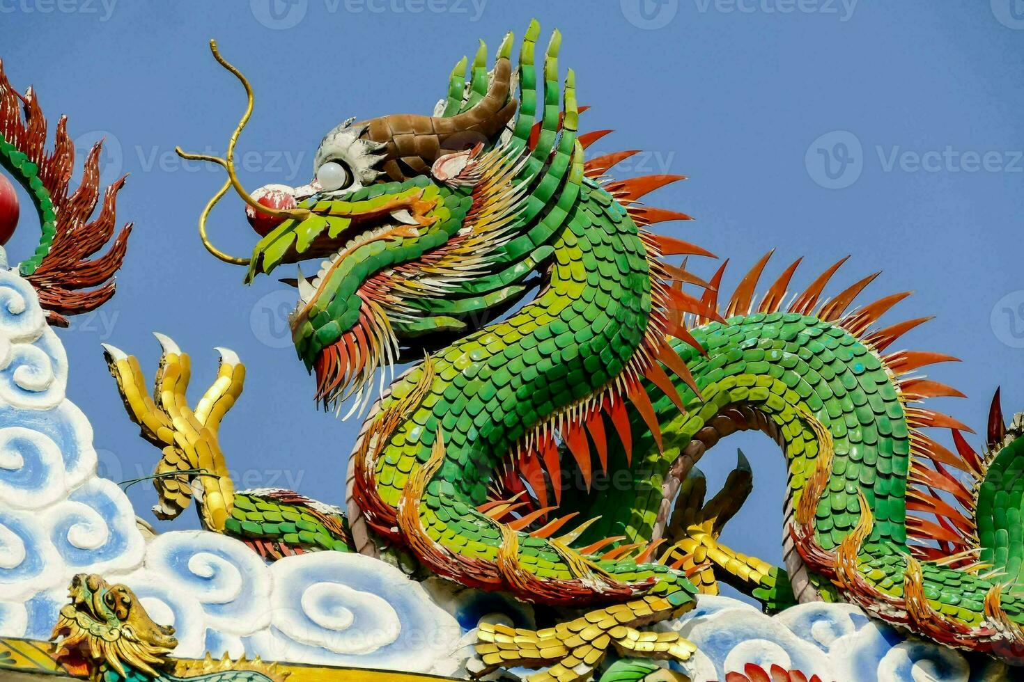 a colorful dragon statue on top of a building photo