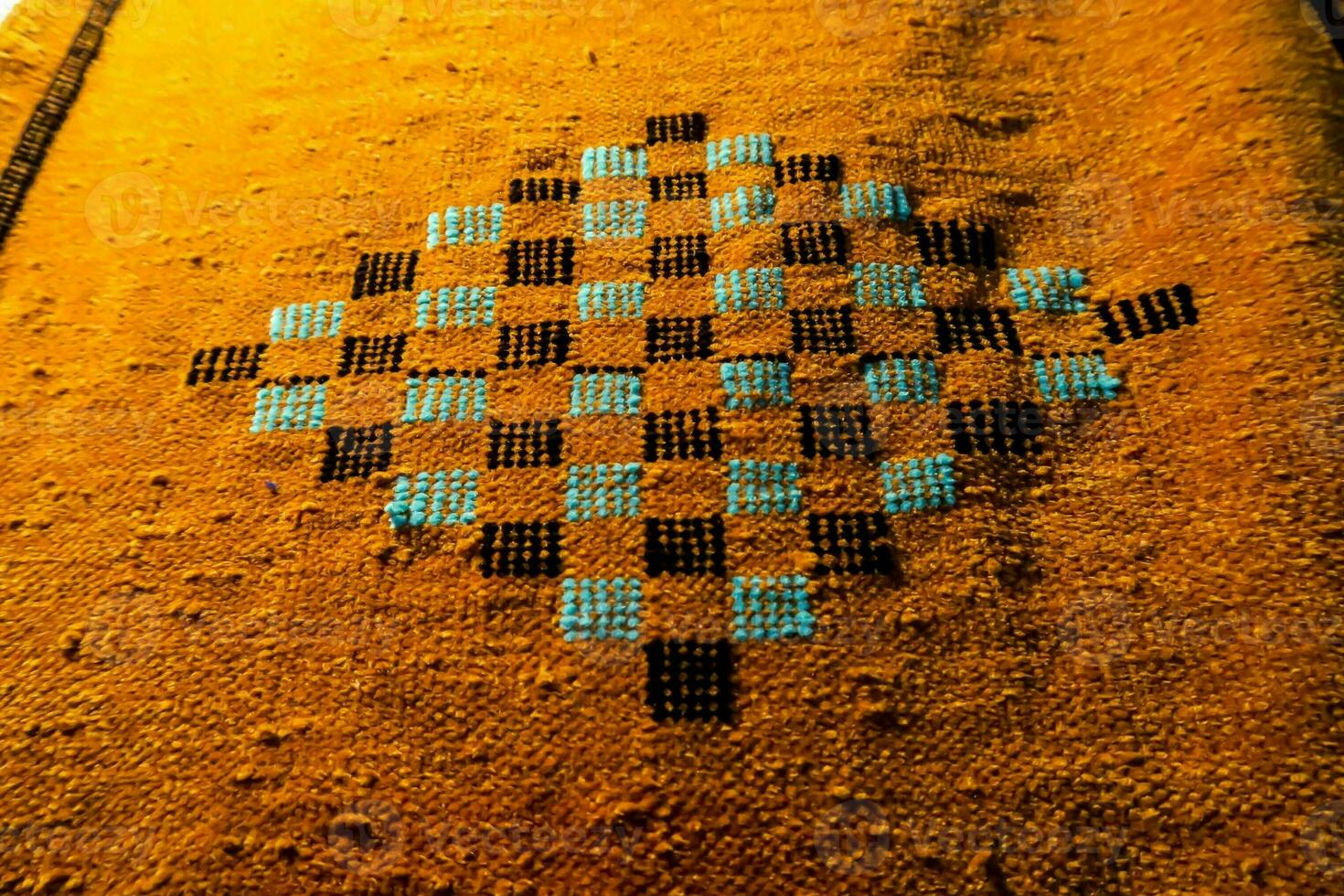 a close up of a cross stitch on a piece of cloth photo