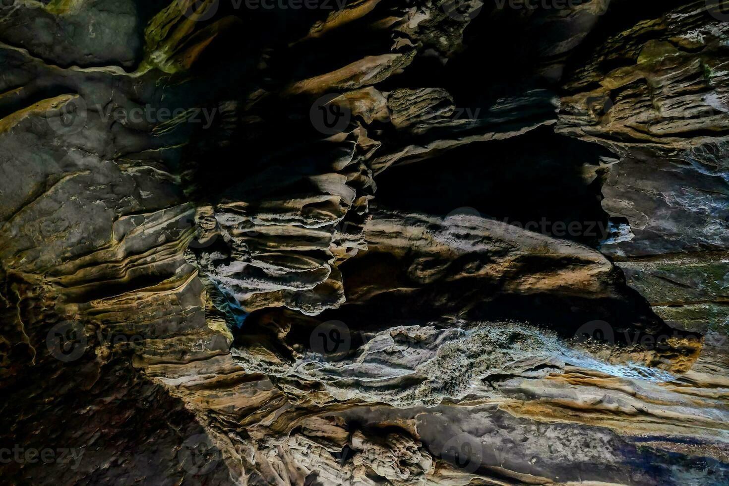 the inside of a cave with a large rock formation photo