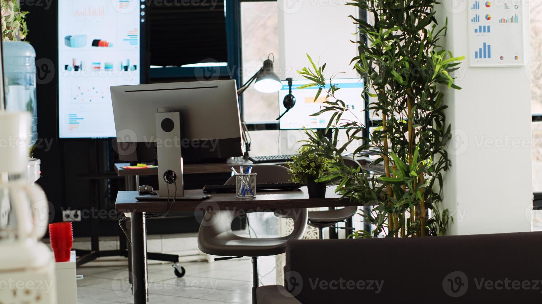 Empty small business open space with desk supplies and company workstations, modern urban building. Startup coworking space used for marketing and research work, boardroom office. photo